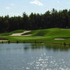 A view of green protected by bunkers with water coming into play at Village Links Golf Club