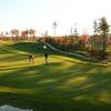 A view of green with narrow path in background at Spring Meadows Golf Club